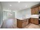 Open kitchen with island, stainless steel appliances, and light wood cabinets at 1511 28Th Street Se Pl, Hickory, NC 28602