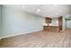 Open living room with kitchen island and wood-look floors at 1511 28Th Street Se Pl, Hickory, NC 28602