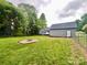 Expansive backyard with a fire pit and detached garage, perfect for outdoor enjoyment and extra storage at 1586 Kenlane Dr, Hickory, NC 28601