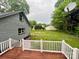 A backyard featuring a wooden deck, grass, and trees beyond a wood railing at 1586 Kenlane Dr, Hickory, NC 28601