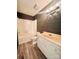 Charming bathroom features wood accent wall, tub/shower, and a vanity with stylish lighting at 1586 Kenlane Dr, Hickory, NC 28601