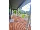 Spacious front porch featuring a wooden deck and white railings to create an inviting space at 1586 Kenlane Dr, Hickory, NC 28601