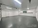 Clean garage space featuring plentiful lighting, workspace, and garage door at 1586 Kenlane Dr, Hickory, NC 28601