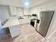 Bright kitchen with white cabinets, stainless steel appliances, and quartz countertops at 1586 Kenlane Dr, Hickory, NC 28601