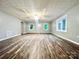 Open living room boasts modern floors, neutral paint, and plenty of natural light from multiple windows at 1586 Kenlane Dr, Hickory, NC 28601