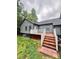 Charming grey home featuring a wooden deck and a freshly manicured lawn, enhancing its curb appeal at 1586 Kenlane Dr, Hickory, NC 28601