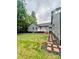 View of the home showing backyard, brick walkway, and fenced-in yard creating a tranquil outdoor space at 1586 Kenlane Dr, Hickory, NC 28601
