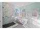 Spa-like bathroom with soaking tub, walk-in shower, and marble tile at 170 Old Post Rd, Mooresville, NC 28117