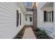 Brick and shingle side entrance with pathway, leading to a white door at 170 Old Post Rd, Mooresville, NC 28117