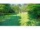 Large grassy backyard with mature trees and a wooden fence at 609 Rowan Mills Rd, Salisbury, NC 28147