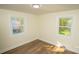 Well-lit bedroom with two windows and hardwood floors at 609 Rowan Mills Rd, Salisbury, NC 28147