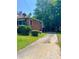 Brick ranch house with a long driveway and side yard at 609 Rowan Mills Rd, Salisbury, NC 28147