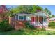 Brick ranch house with a red front door and a white porch at 609 Rowan Mills Rd, Salisbury, NC 28147