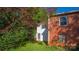 Brick house exterior with a detached building and blooming tree at 609 Rowan Mills Rd, Salisbury, NC 28147