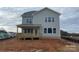 A beautiful back exterior showcasing a wooden deck, light green siding, and picturesque view of the neighborhood at 4808 Glen Stripe Dr # Cal0036, Indian Trail, NC 28079