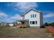 Back exterior view showcasing a covered wood deck and ample space in the backyard at 4808 Glen Stripe Dr # Cal0036, Indian Trail, NC 28079