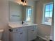 Stylish bathroom vanity featuring a white countertop, dark hardware, and contemporary lighting at 4808 Glen Stripe Dr # Cal0036, Indian Trail, NC 28079