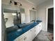 Bathroom featuring double sinks, modern lighting fixtures, and a large mirror at 4808 Glen Stripe Dr # Cal0036, Indian Trail, NC 28079