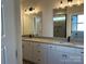 Bathroom featuring double sinks, vanity, mirrors and a glass-enclosed shower with tiled walls at 4808 Glen Stripe Dr # Cal0036, Indian Trail, NC 28079