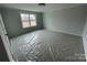 A bedroom featuring neutral walls, a window, and new construction elements at 4808 Glen Stripe Dr # Cal0036, Indian Trail, NC 28079