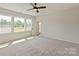 Bright bedroom with large windows offering natural light and backyard views, plus a ceiling fan at 4808 Glen Stripe Dr # Cal0036, Indian Trail, NC 28079