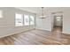 Bright dining room with large windows, wood-look flooring, and modern chandelier at 4808 Glen Stripe Dr # Cal0036, Indian Trail, NC 28079