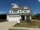 Charming two-story home with attached garage, landscaped yard, and Craftsman-style details at 4808 Glen Stripe Dr # Cal0036, Indian Trail, NC 28079