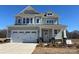 Charming two-story home with a two-car garage, stone accents, and inviting front porch at 4808 Glen Stripe Dr # Cal0036, Indian Trail, NC 28079