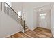 Welcoming foyer with hardwood floors, a staircase with iron railing, and a bright, airy ambiance at 4808 Glen Stripe Dr # Cal0036, Indian Trail, NC 28079