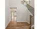 Bright and open foyer with hardwood floors, elegant staircase, and views into the spacious living area at 4808 Glen Stripe Dr # Cal0036, Indian Trail, NC 28079