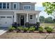 Charming front porch featuring stone accents, white columns, and a well-manicured landscape at 4808 Glen Stripe Dr # Cal0036, Indian Trail, NC 28079