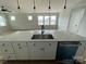 Modern kitchen island with stainless steel sink, black faucet, and dishwasher at 4808 Glen Stripe Dr # Cal0036, Indian Trail, NC 28079