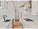 Well-lit kitchen showcasing a deep sink, white cabinets, gas cooktop, stainless steel appliances, and wood-look flooring at 4808 Glen Stripe Dr # Cal0036, Indian Trail, NC 28079