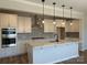 Modern kitchen featuring white cabinets, stainless steel appliances, island, and pendant lighting at 4808 Glen Stripe Dr # Cal0036, Indian Trail, NC 28079