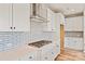 Bright kitchen featuring white cabinets, subway tile backsplash, stainless steel vent hood, and gas cooktop at 4808 Glen Stripe Dr # Cal0036, Indian Trail, NC 28079