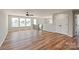 Living room featuring hardwood floors, many windows, stairs and a ceiling fan at 4808 Glen Stripe Dr # Cal0036, Indian Trail, NC 28079