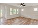 Comfortable living room featuring wood-look floors, large windows for ample light, and neutral color scheme at 4808 Glen Stripe Dr # Cal0036, Indian Trail, NC 28079