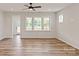 Spacious living area with wood-look flooring, large windows providing natural light, and access to an outdoor area at 4808 Glen Stripe Dr # Cal0036, Indian Trail, NC 28079