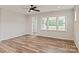 Inviting living room boasting wood-look floors, large windows offering a view, and neutral decor at 4808 Glen Stripe Dr # Cal0036, Indian Trail, NC 28079
