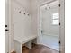 Bright mudroom features a built-in bench with storage and coat hooks, leading to the laundry room at 4808 Glen Stripe Dr # Cal0036, Indian Trail, NC 28079