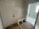 A well-lit mudroom with a built-in bench and coat hooks, adjacent to a laundry area at 4808 Glen Stripe Dr # Cal0036, Indian Trail, NC 28079