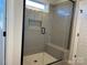 Modern bathroom showcasing a tiled shower with glass enclosure, bench seating, and sleek fixtures at 4808 Glen Stripe Dr # Cal0036, Indian Trail, NC 28079