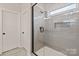 Glass enclosed walk-in shower with tile surround and window at 4808 Glen Stripe Dr # Cal0036, Indian Trail, NC 28079