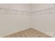 Walk-in closet with wire shelving and neutral carpet at 4808 Glen Stripe Dr # Cal0036, Indian Trail, NC 28079
