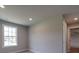 Well-lit bedroom with window, carpet, and door to another room at 1133 Heather Oak Ln, Oakboro, NC 28129