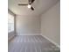 Simple bedroom with carpet, large window, and ceiling fan at 1133 Heather Oak Ln, Oakboro, NC 28129