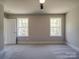 Spacious bedroom with carpet, two windows, and ceiling fan at 1133 Heather Oak Ln, Oakboro, NC 28129