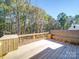 Spacious wooden deck with built-in seating, overlooking a wooded area at 1133 Heather Oak Ln, Oakboro, NC 28129