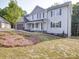 Light blue two-story home featuring black shutters, a well-maintained yard, and a brick two-car garage at 1133 Heather Oak Ln, Oakboro, NC 28129