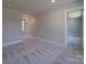 Upstairs hallway with carpet and doors to bedrooms at 1133 Heather Oak Ln, Oakboro, NC 28129